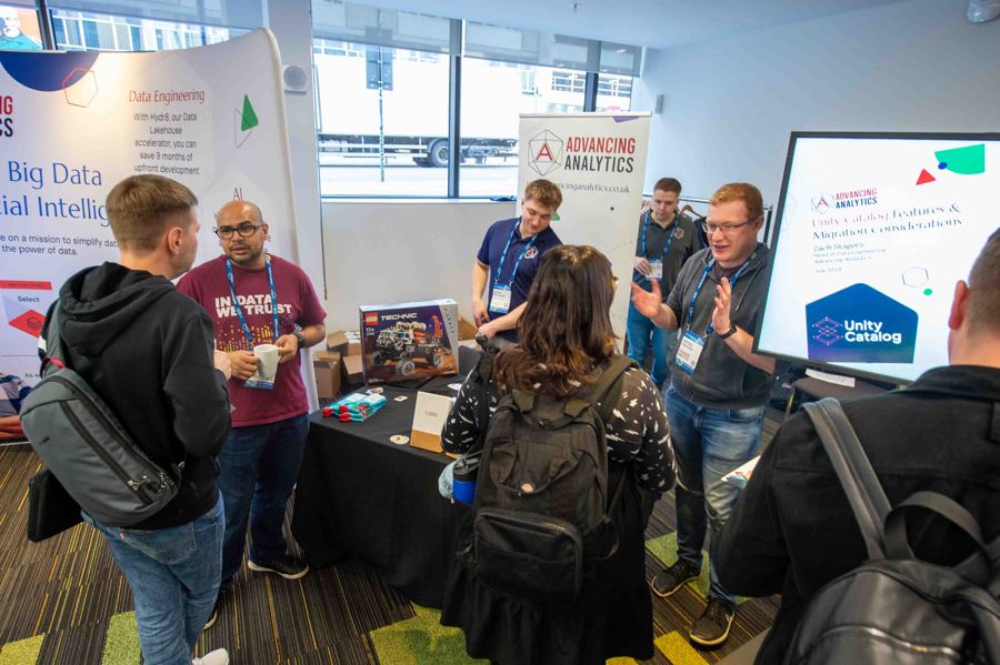 Attendees visiting a sponsor stand in 2024